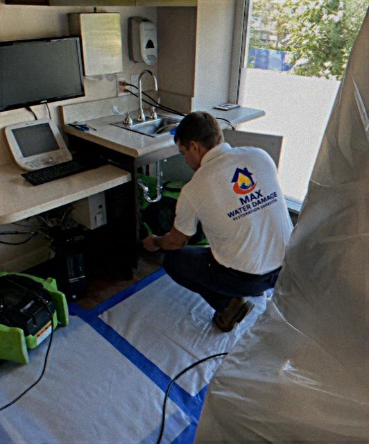 Max technician drying out under-sink water damage
