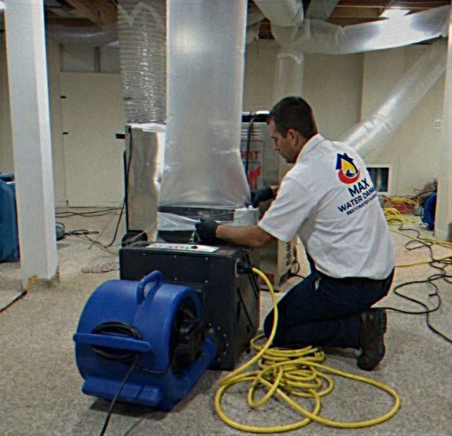 Max technician setting up negative air and ducting equipment