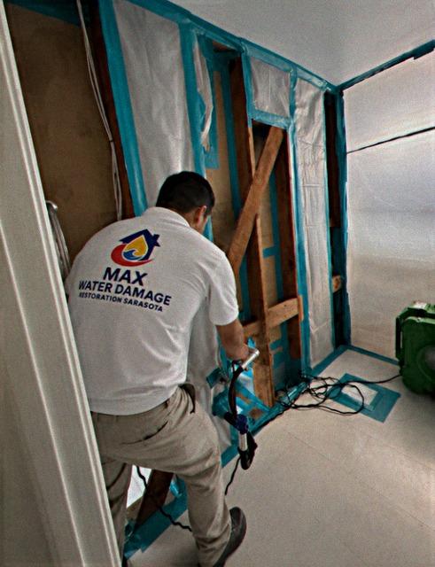 Max technician working on an opened water damaged wall